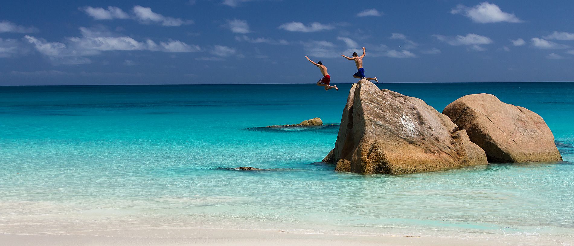 Seychelles holidays - kids jumping off rocks