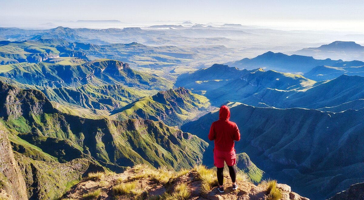 Man overlooking the Amphtheatre of the Drakensberg Mountains