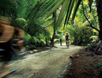 Cycling in forest on Desroches island, outer islands of Seychelles