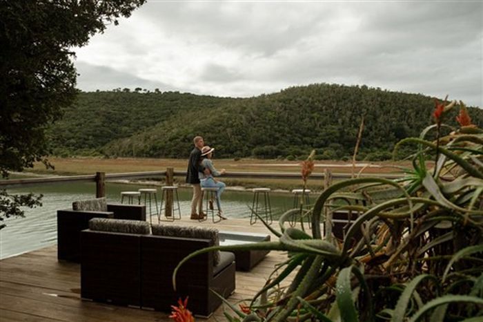 Couple over looking the river from the deck at Kariega River Lodge - courtesy of Kariega River Lodge 