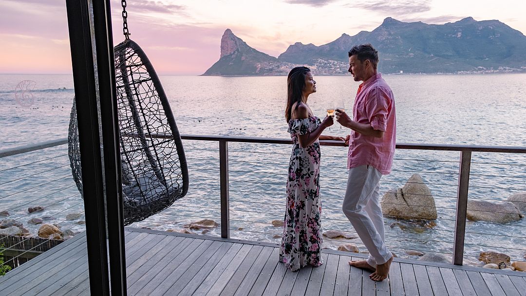 Honeymoon destinations in Africa - couple man and women drinking coffee during sunrise in Cape Town South Africa.
